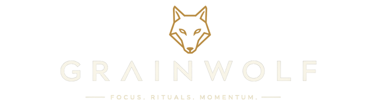 A minimalist logo featuring a gold fox head icon above the word 'GRAINWOLF' in a light beige serif font, with the tagline 'FOCUS. RITUALS.